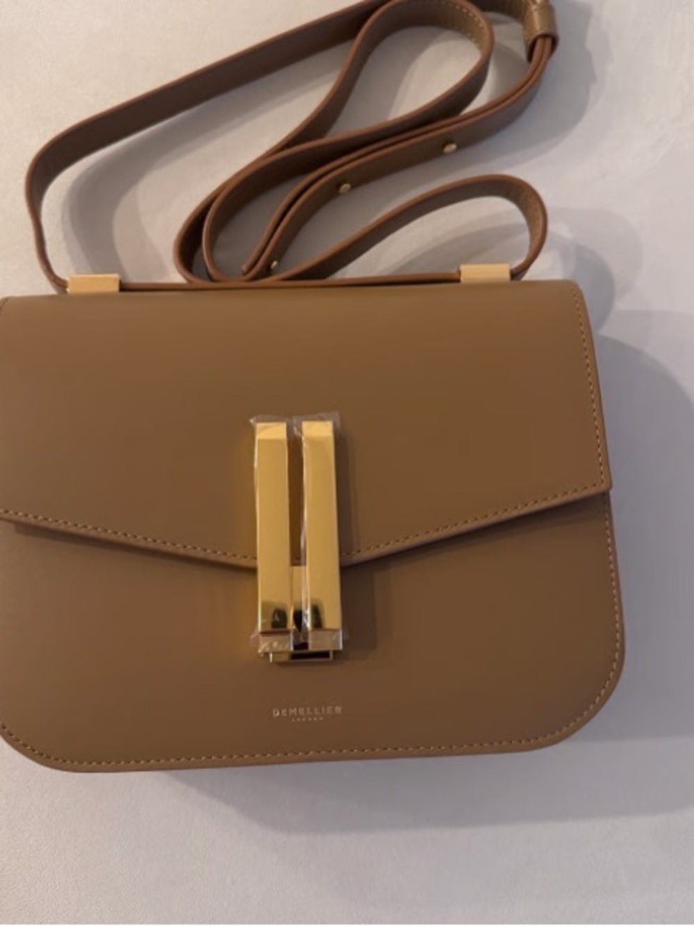 DeMellier tan crossbody with gold-tone clasp